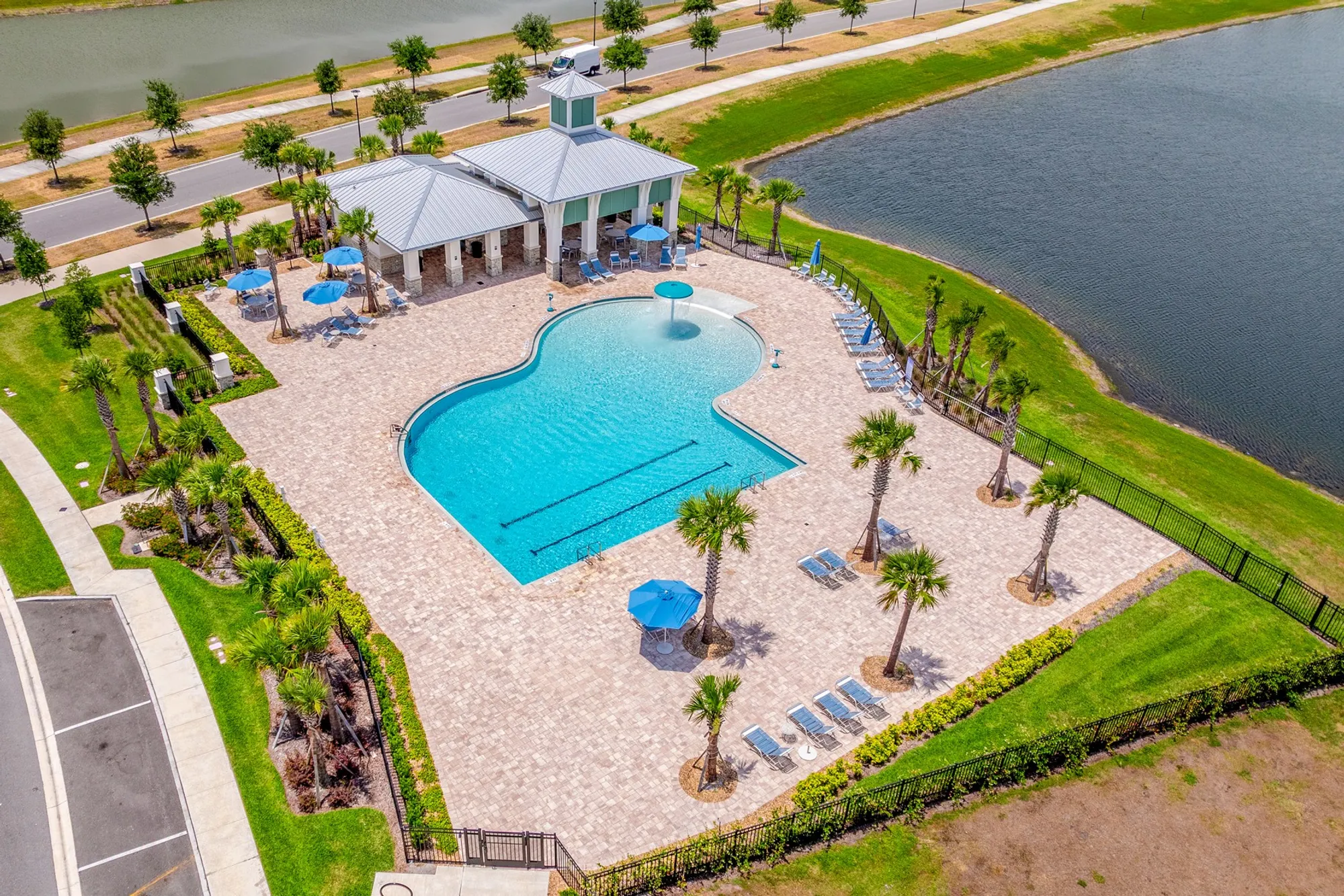 Aerial view of the community pool and lakes at The Reserve Of Twin Lakes